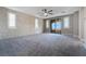 Spacious bedroom featuring a ceiling fan, stylish wall accent, and sliding doors to a covered patio at 12279 Lost Treasure Ave, Las Vegas, NV 89138