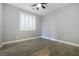 A minimalist bedroom with shutters, neutral walls, and light wood-look flooring at 12279 Lost Treasure Ave, Las Vegas, NV 89138