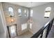 Inviting two-story foyer boasts abundant natural light, stone accent wall, and elegant chandelier at 12279 Lost Treasure Ave, Las Vegas, NV 89138