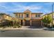 Daylight view of a two-story house, showing the home's architectural features, landscaping, and three-car garage at 12279 Lost Treasure Ave, Las Vegas, NV 89138