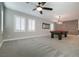 Carpeted game room includes a pool table, shuttered windows, and a modern ceiling fan at 12279 Lost Treasure Ave, Las Vegas, NV 89138