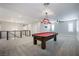 Carpeted game room with pool table, modern ceiling fan, and abundant natural light at 12279 Lost Treasure Ave, Las Vegas, NV 89138