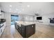 Bright, open-concept kitchen with island and stainless steel appliances seamlessly flowing to the outdoor pool area at 12279 Lost Treasure Ave, Las Vegas, NV 89138