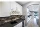 Modern kitchen with granite counters, a wine fridge, and brick backsplash at 12279 Lost Treasure Ave, Las Vegas, NV 89138