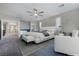 Staged main bedroom featuring a luxurious bed, sitting area, accent wall, and elegant decor at 12279 Lost Treasure Ave, Las Vegas, NV 89138