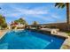 Gorgeous pool features a stone water feature with an outdoor seating area and landscaping at 12279 Lost Treasure Ave, Las Vegas, NV 89138