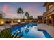 Inviting backyard pool and spa with lounge area and fire bowls, perfect for outdoor entertaining at twilight at 12279 Lost Treasure Ave, Las Vegas, NV 89138