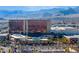 Daytime aerial view of the Red Rock Casino with a backdrop of scenic mountains and palm tree-lined parking area at 12279 Lost Treasure Ave, Las Vegas, NV 89138