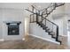 Modern staircase with metal railings and an adjacent fireplace in a bright, open living space at 12279 Lost Treasure Ave, Las Vegas, NV 89138