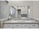 A bathroom featuring double sinks, quartz countertops and a walk-in shower at 12374 Skyracer Dr, Las Vegas, NV 89138