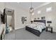 Well-lit bedroom featuring an open layout, neutral decor, modern light fixture, and patterned carpet at 12374 Skyracer Dr, Las Vegas, NV 89138