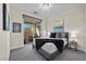 Relaxing bedroom with sliding glass door, neutral decor, bedside table and lamps, patterned carpet, and artwork at 12374 Skyracer Dr, Las Vegas, NV 89138