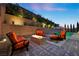 Outdoor seating area with a fire pit and lush landscaping at 12374 Skyracer Dr, Las Vegas, NV 89138