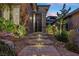 Inviting front entrance with stylish brick steps, modern metal gate, and landscape features at 12374 Skyracer Dr, Las Vegas, NV 89138