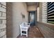 Cozy front porch featuring a charming white bench and a modern front door at 12374 Skyracer Dr, Las Vegas, NV 89138