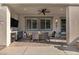 Outdoor dining area with a ceiling fan, table for six, and a built-in bar area at 12374 Skyracer Dr, Las Vegas, NV 89138