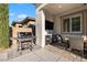 An outdoor kitchen with a built-in bar, grill, and dining area at 12374 Skyracer Dr, Las Vegas, NV 89138