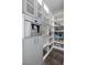 Organized pantry with custom shelves and cabinets, offering ample storage space with built in coffee machine at 12374 Skyracer Dr, Las Vegas, NV 89138