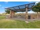 Community park area featuring picnic tables under a decorative metal awning and well-maintained landscaping at 12374 Skyracer Dr, Las Vegas, NV 89138