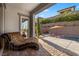 Relaxing poolside patio featuring a daybed, lounge chairs, and lush landscaping at 12374 Skyracer Dr, Las Vegas, NV 89138