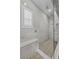 Walk-in shower with marble tiling, built-in bench, and glass enclosure at 12374 Skyracer Dr, Las Vegas, NV 89138