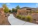 Stone entrance sign for Shadow Point, set amidst lush landscaping and a curved walkway at 12374 Skyracer Dr, Las Vegas, NV 89138