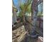 Backyard showcasing mature trees, decorative landscaping, and a fenced perimeter at 1395 Kapelle St, Henderson, NV 89052