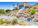 Stunning waterfall feature cascading over rocks into a tranquil pond, enhancing the building's landscaped grounds at 1395 Kapelle St, Henderson, NV 89052