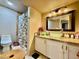 Bathroom featuring modern vanity with vessel sink, decorative mirror, and walk-in shower at 1908 Tierra Vista Dr # 206, Las Vegas, NV 89128