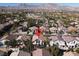 Neighborhood aerial view of a home nestled among other houses and lush trees with mountains in the distance at 2008 Arbor Forest St, Las Vegas, NV 89134