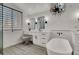 Bright bathroom with a luxurious soaking tub, walk-in shower, and dual vanity sinks offering modern elegance at 2008 Arbor Forest St, Las Vegas, NV 89134