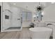 A spacious primary bathroom featuring a freestanding tub, glass shower, and double vanity sinks with modern fixtures at 2008 Arbor Forest St, Las Vegas, NV 89134