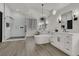 Stunning bathroom showcasing a glass shower, standalone tub, and dual vanities with unique light fixture at 2008 Arbor Forest St, Las Vegas, NV 89134