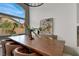 Bright dining room with a large window, chandelier, and a wooden table at 2008 Arbor Forest St, Las Vegas, NV 89134