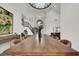 Bright dining room with a large window, chandelier, and a wooden table at 2008 Arbor Forest St, Las Vegas, NV 89134