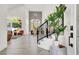 Inviting entryway with staircase, featuring a view of the living room, dining area, and large windows at 2008 Arbor Forest St, Las Vegas, NV 89134