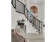 Bright foyer featuring a staircase with black metal railings and luxury vinyl plank flooring at 2008 Arbor Forest St, Las Vegas, NV 89134