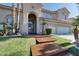 Inviting home with a well-kept lawn, palm trees, and a charming front entrance with a tiled walkway at 2008 Arbor Forest St, Las Vegas, NV 89134