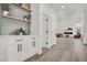 Hallway with a built-in cabinet, floating shelves, modern lighting, and access to the living room at 2008 Arbor Forest St, Las Vegas, NV 89134