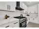 Kitchen features white cabinets, quartz countertops, stainless steel appliances, and a gas range at 2008 Arbor Forest St, Las Vegas, NV 89134