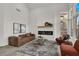 Bright living room with a modern fireplace, plush seating, and large windows at 2008 Arbor Forest St, Las Vegas, NV 89134