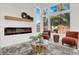 Cozy living room featuring a modern fireplace, accent wall, and ample natural light for a serene atmosphere at 2008 Arbor Forest St, Las Vegas, NV 89134