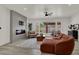 Spacious living room featuring a modern fireplace, comfortable sofa, area rug, and a backyard view at 2008 Arbor Forest St, Las Vegas, NV 89134