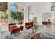 Chic living room featuring an expansive window overlooking the pool and lush greenery, creating an indoor-outdoor living experience at 2008 Arbor Forest St, Las Vegas, NV 89134