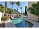 Backyard pool with a rock waterfall, surrounded by lush landscaping offering a private and serene retreat at 2008 Arbor Forest St, Las Vegas, NV 89134