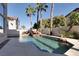 The backyard features a large pool with mature landscaping and a decorative rock waterfall at 2008 Arbor Forest St, Las Vegas, NV 89134