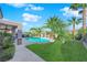 A well-manicured backyard features a pool, a covered patio, and lush landscaping at 2244 Garden City Ave, Henderson, NV 89052