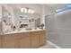 Inviting bathroom with double sinks, well-lit vanity, and a glass-enclosed shower for a spa-like experience at 2244 Garden City Ave, Henderson, NV 89052