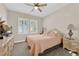 Cozy bedroom with natural light streaming through shuttered windows, ceiling fan, and carpet floors at 2244 Garden City Ave, Henderson, NV 89052