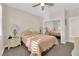 Cozy bedroom featuring neutral walls, ceiling fan, mirrored closet and a comfortable bed at 2244 Garden City Ave, Henderson, NV 89052